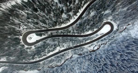 AERIAL: Road in Forest with snow in Dolomites