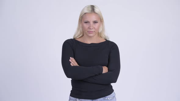 Young Angry Blonde Woman with Arms Crossed