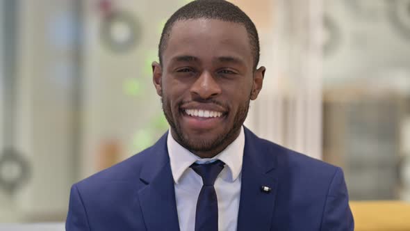 Portrait of African Businessman Saying Yes By Shaking Head