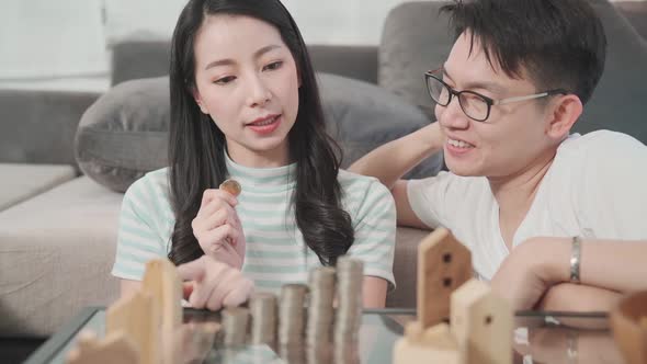 young attractive male and female asian couple focus concentrate money saving