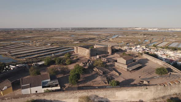 Castro Marim Castle aerial pullback.Fortified structure on hilltop overlooking the town