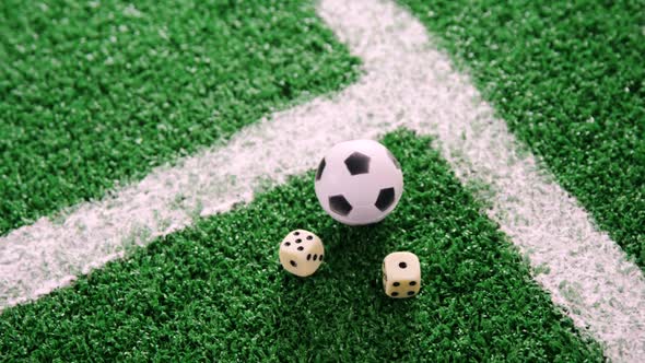 Football and dice on artificial grass 4k