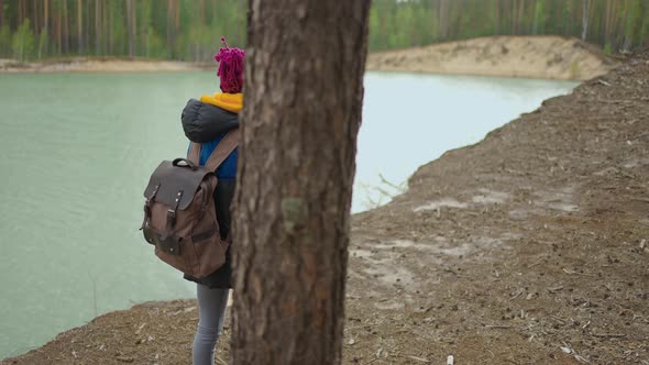 Back View of One Black Woman Walk and Looking on Mountain and Lake