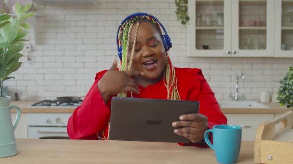 Joyful Black Female Browsing Content on Tablet Pc