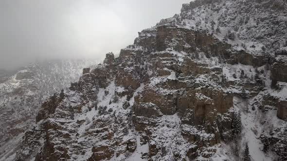 Snow covered mountain side viewed from drone