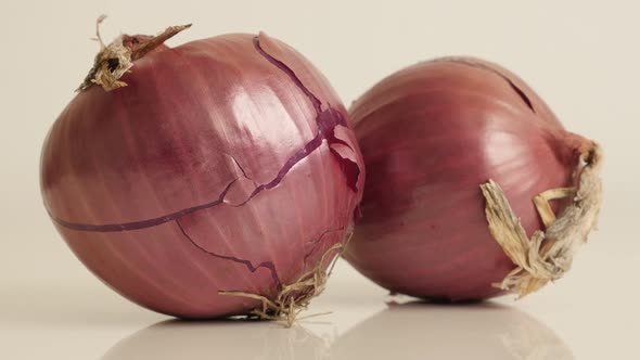 Tilting over red skin and white flesh onion close-up 4K 2160p 30fps UltraHD footage - Organic Allium