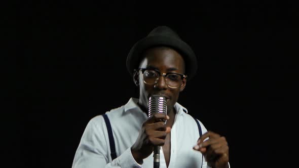 Man Young African American Approaching the Microphone Singing in a Recording Studio. Black