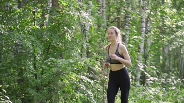 Fitness Woman Runs in Autumn Morning Park