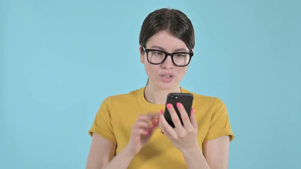 Disappointed Young Woman Feeling Sad While Using Phone on Purple Background