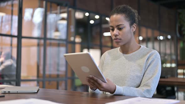 African Woman Using Digital Tablet at Work