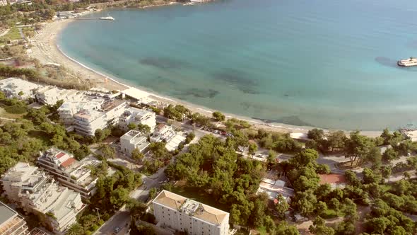 Aerial view of holiday buildings in front of the beach at Alithini, Syros island