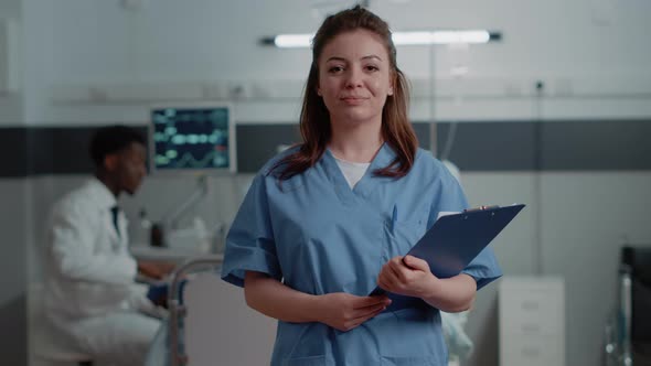 Portrait of Medical Assistant Holding Checkup Documents