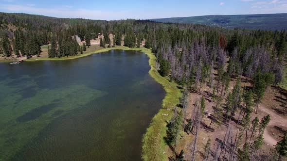 Flying above shoreline of lake from above campsite