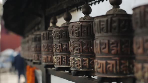 A Close View of Spinning Buddhist Prayer Wheels in a Row of Wheels in Nepal Kathmandu. Temple.