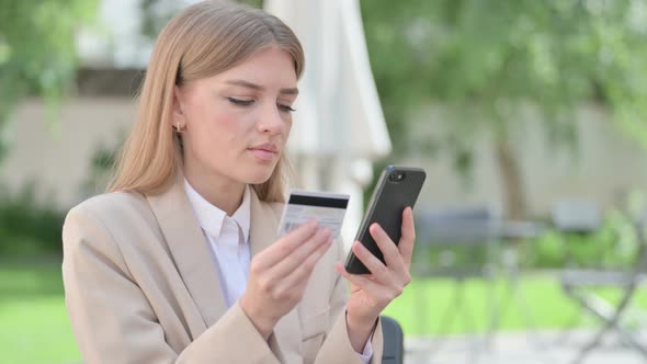 Outdoor Young Businesswoman Making Online Payment on Smartphone