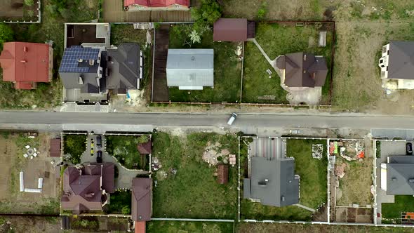 Aerial view of houses on housing estates, some with building on roof panels