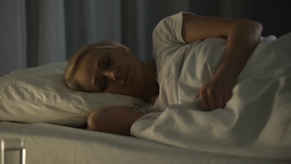Bad Looking Senior Woman Sleeping Seeing Nightmares and Feeling Pain in Dream
