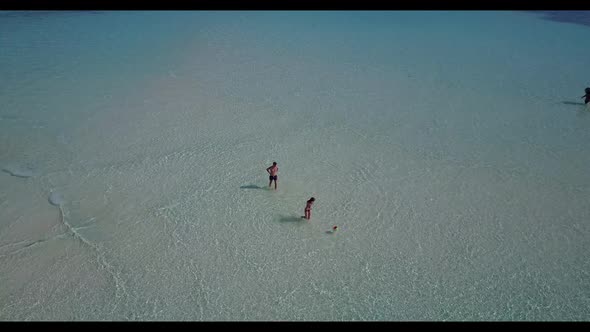 Boy and girl happy together on beautiful resort beach break by shallow water and clean sand backgrou