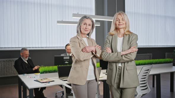 Zoom in Portrait of Two Confident Professional Elderly Business Ladies in Formal Wear Posing at