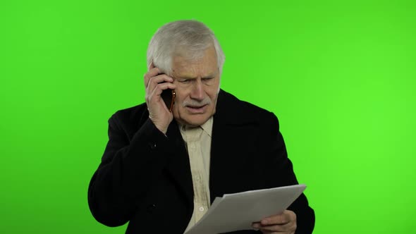 Elderly Stylish Caucasian Grandfather Man Dissatisfied Talking on Mobile Phone