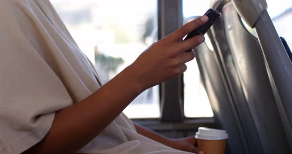 Female commuter using mobile phone while travelling in bus 4k