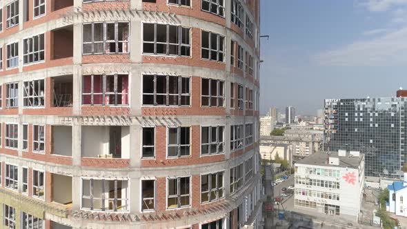 Aerial shot of construction of high-rise apartment buildings and cranes in city 20