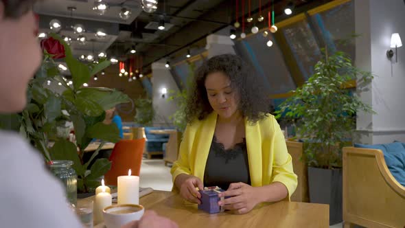 Excited Young Girl is Getting Gift From Boyfriend Feeling Happy and Smilingtrying to Guess What's