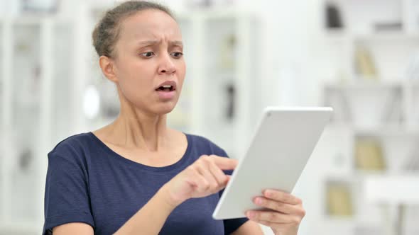 Portrait of African Woman Having Loss on Tablet 