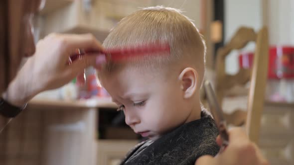 Mom Is Cutting Her Little Son Hair at Home.