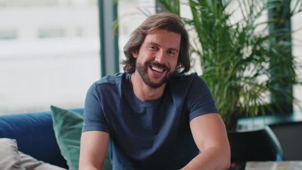 Portrait of handsome man in living room 