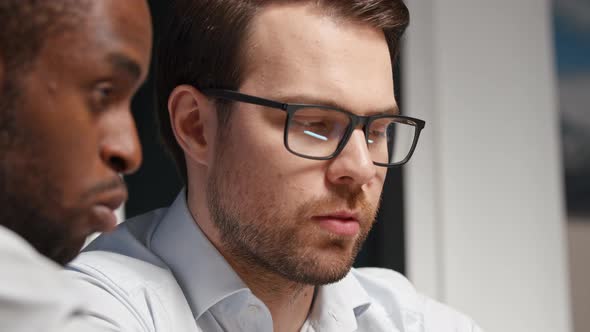 Young colleagues working together sitting in a meeting