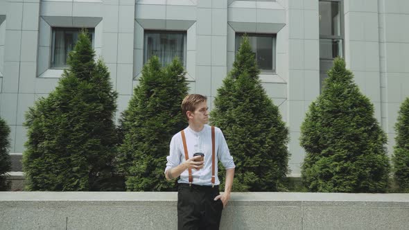 Medium Shot Portrait of Man with a Cup of Coffee Person Dressed in Stylish Clothes Slow Motion