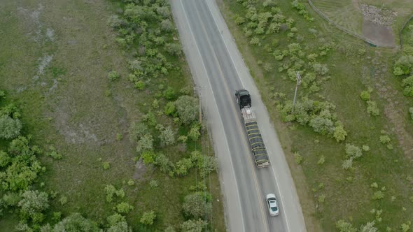 Aerial Drone View of Truck Rides on Road That Turns