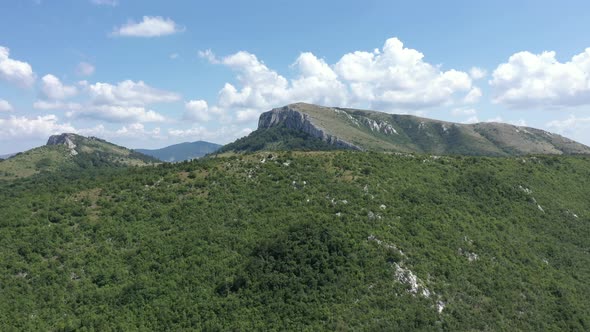 Ascending over the forest on top of the Stol mountain in Serbia 4K aerial video