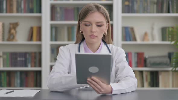 Lady Doctor Using Tablet in Clinic