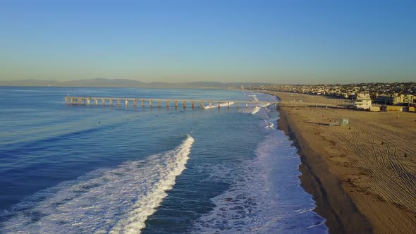 Aerial drone uav view of a pier over the beach and ocean.