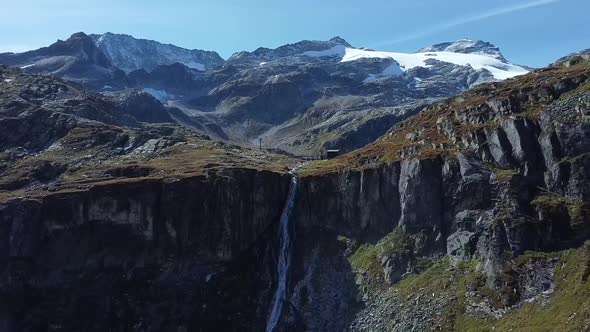 Flying away with a drone from a imposing waterfall that originates from the weissee,  Hohe Tauern Na