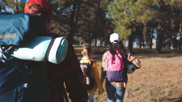 Happy Family Hiking Through a Forest