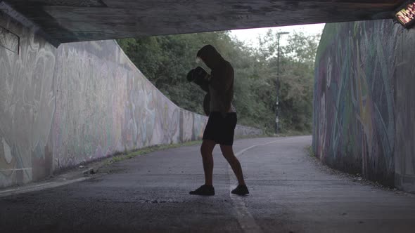 Wide Shot of Young Attract Man Boxing In Underpass, In Slow Motion. - Ungraded