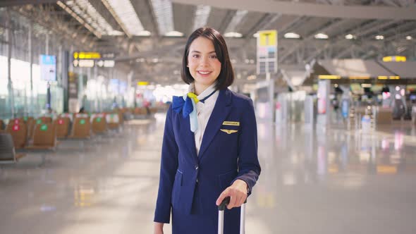 Portrait of beautiful Caucasian flight attendant staff smiling and looking at camera with confidence