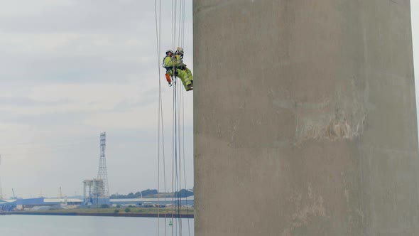 Safety Inspectors Working at Height on a Concrete Bridge Checking for Cracks