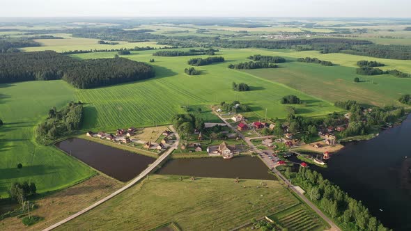 View From the Height of the Lake in a Green Field in the Form of a Horseshoe and a Village