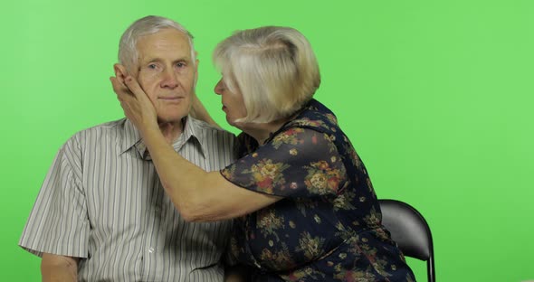 Funny Senior Aged Man and Woman Sitting Together. Concept of a Happy Old Family