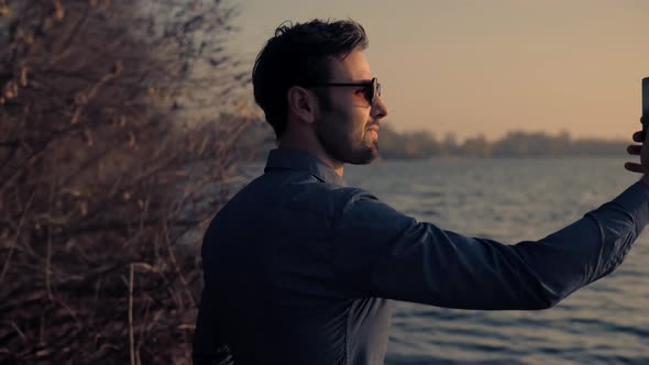 Satisfied Man Taking Selfie On Mobile Phone. Businessman In White Shirt Taking Self Photo.