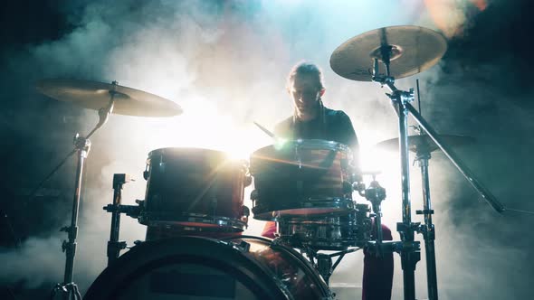 Clouds of Smoke in a Recording Studio with a Man Playing Drums