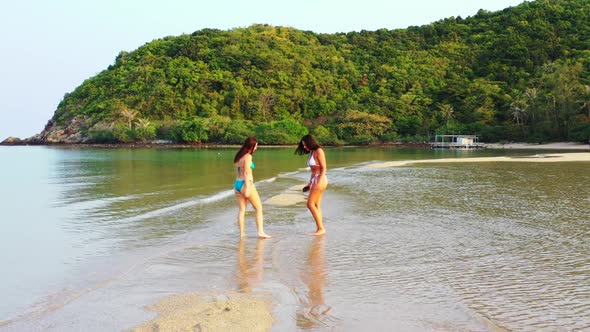 Women relaxing on beautiful seashore beach time by aqua blue sea and white sand background of Koh Ph