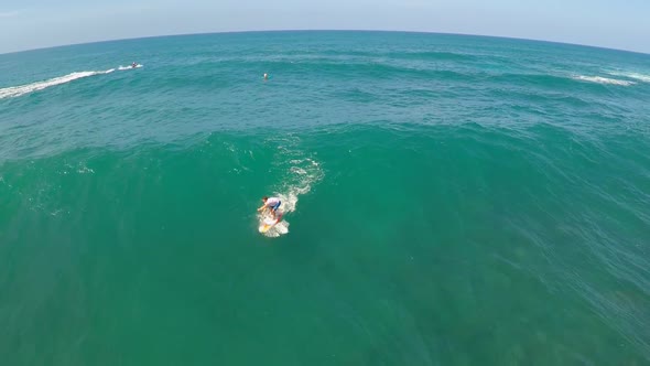 Aerial view of a wipeout while sup stand-up paddleboard surfing in Hawaii