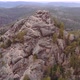 Aerial Shot of Tourists Climb To the Top of the Rock in the Siberian Natural Park Stolby - VideoHive Item for Sale