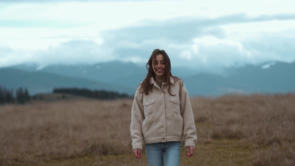 Joyful Freedom Ukrainian Girl in Jacket Standing Against Mountains Hills and Dramatic Cloudy Sky