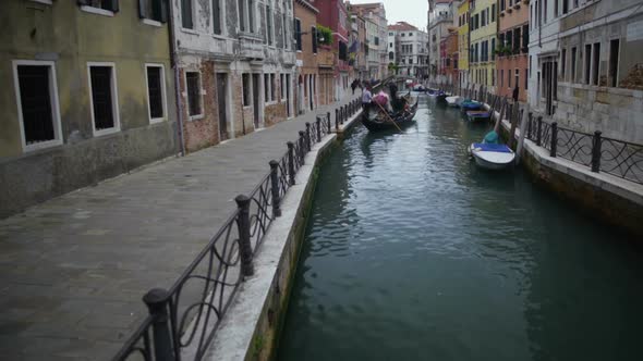 Gondola Carrying Tourists Along Nice Narrow Street in Venice, Travel to Italy